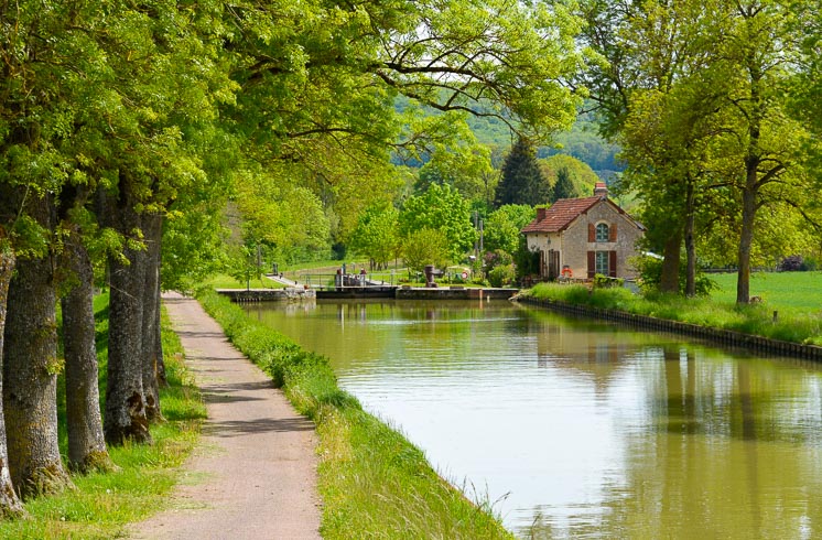 A bike path runs along a canal in the Ouche valley of Burgundy
