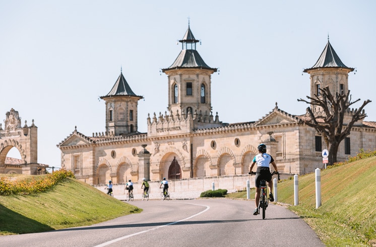 Cyclist approaching Château Cos d’Estournel in Bordeaux